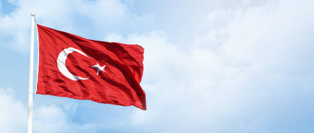 istock Turkish flag waving in the blue, cloudy sky. 2166791490