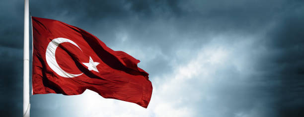 istock The Turkish flag waving among dark clouds. 2166791531