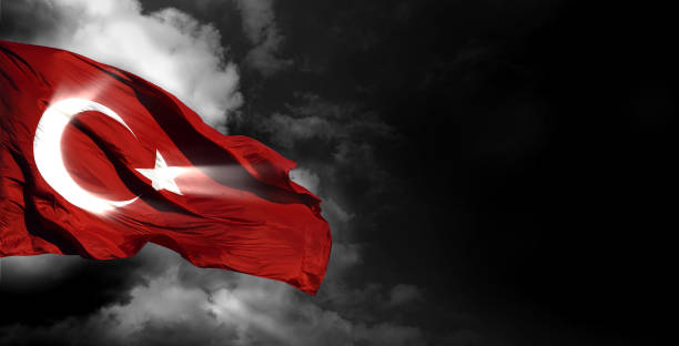 istock The Turkish flag waving among dark clouds. 2166791539