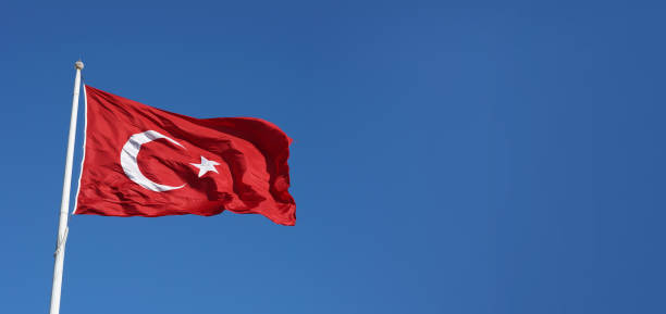 istock Turkish flag waving in the blue, cloudy sky. 2166791585