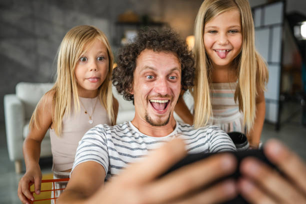 istock father take self portrait or have video call with his daughters 2166795044