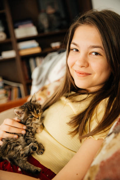 istock Young girl holding little kitten and cuddle with her 2166795218