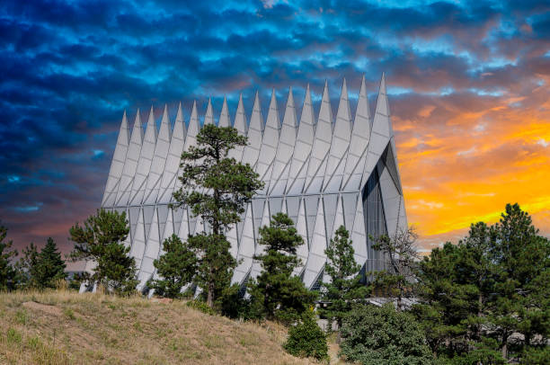 Mormon or LDS church with a spire under a cloudy stormy sky.