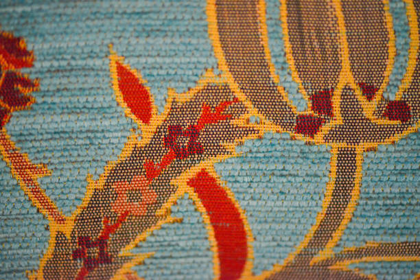 A macro photo highlighting the intricate and luxurious texture of a turquoise-colored Ottoman sofa, showcasing the detailed craftsmanship and rich cultural heritage of its design.