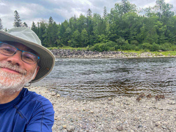 istock Selfie of mature man with river 2166800501
