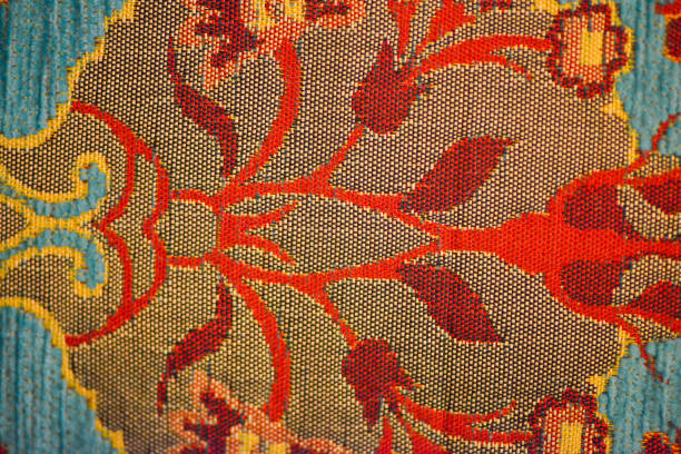 A macro photo highlighting the intricate and luxurious texture of a turquoise-colored Ottoman sofa, showcasing the detailed craftsmanship and rich cultural heritage of its design.