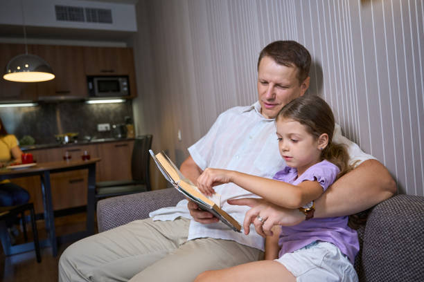 istock Father reading a book to his little daughter 2166802245