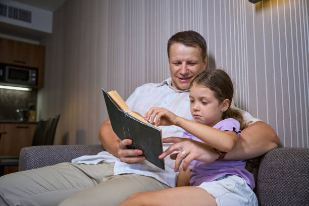 istock Father reading a book to his little daughter 2166802256