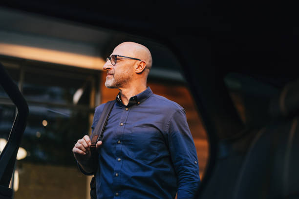 istock Confident Businessman Exiting Car in Urban Setting 2166802693