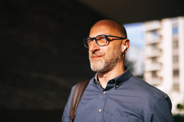 istock Confident Businessman Walking in the City with Bluetooth Earbuds 2166802719