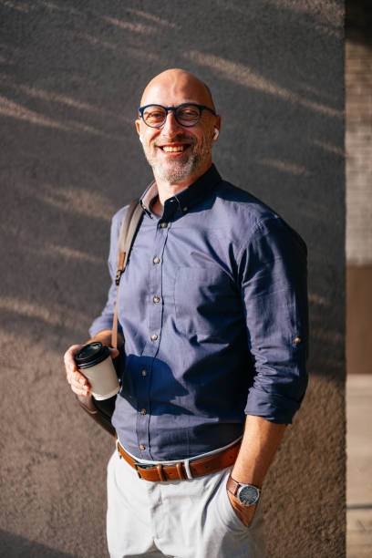 istock Confident Businessman Smiling Outdoors with Coffee and Glasses 2166802729