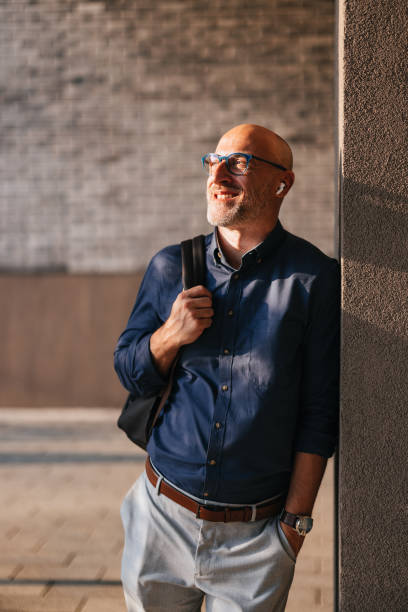 istock Smiling Businessman Relaxing Outdoors in Urban Setting 2166802752