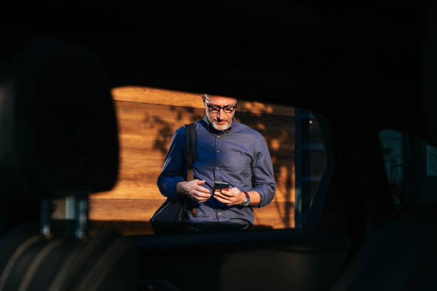 istock Businessman Checking Phone While Walking in Urban Setting 2166802753