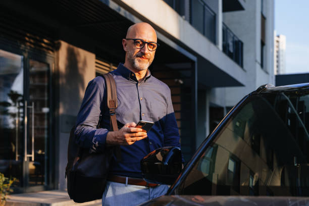 istock Businessman Standing Next to Car in Urban Environment 2166802756