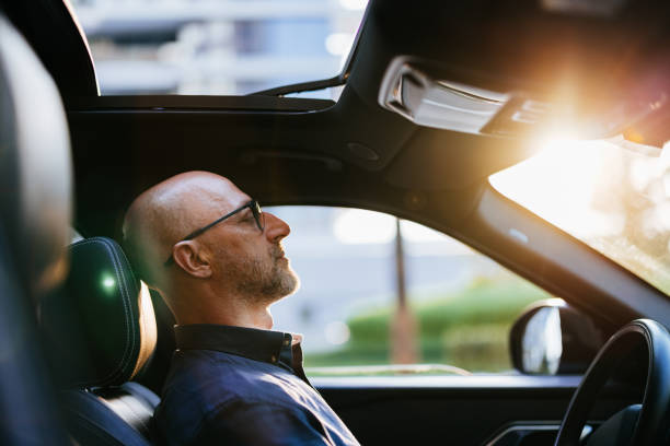 istock Businessman Relaxing in a Car with Sunlight Streaming In 2166802765