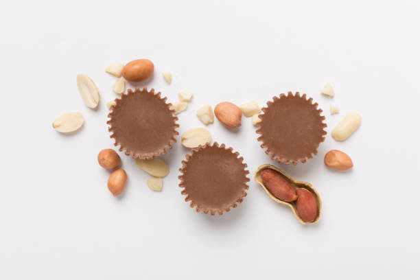 istock Tasty chocolate peanut butter cups on color background, top view 2166804462