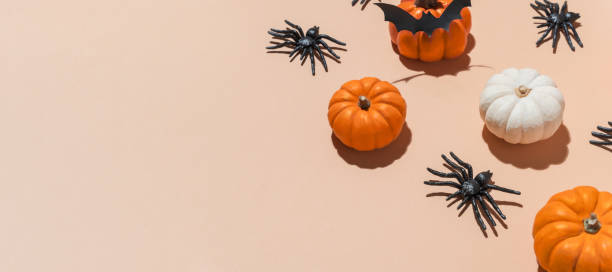 istock Halloween banner pumpkin pattern with trendy hard shadows. Orange pumpkins and black spiders pattern on pastel background. Decoration for Halloween party. Copy space, blogs, promotions. 2166807075