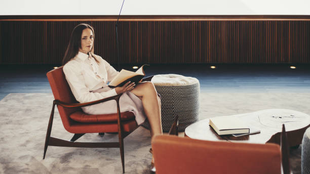 istock Woman reading in minimalist room 2166807945