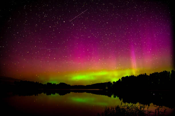 istock red green aurora borealis in lake with clouds 2166808055