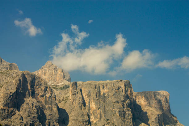 dramatic view on mountain peaks of italian alps with moon