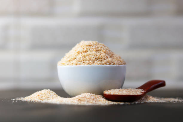 istock Psyllium Husk (Isabgol) in a ceramic bowl with a wooden spoon on a grey background 2166811978