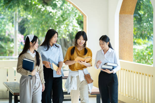 istock Group of students walking in campus hallway . 2166813266