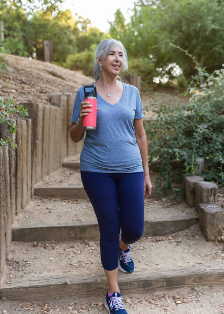 istock Senior woman walking down foot path stairs 2166817117
