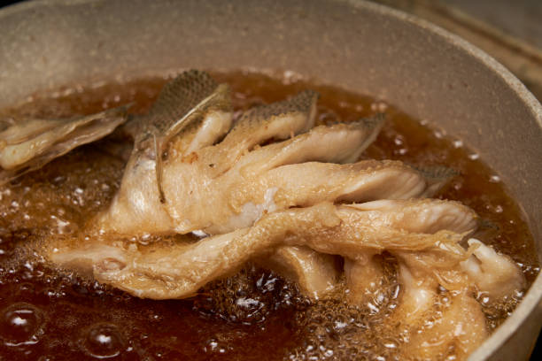 istock A chef in the kitchen is making fried fish, frying a whole fish 2166822787