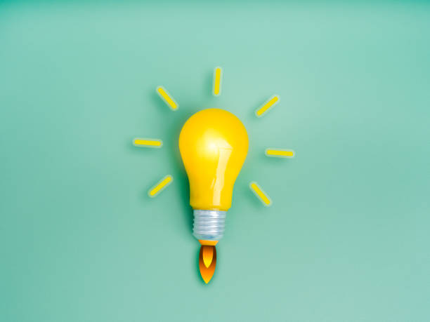 istock Business startup, creative idea, inspiration, education knowledge and learning, innovation concept. Yellow lightbulb as spaceship or rocket launch with fire smoke graphic on light green background. 2166822959