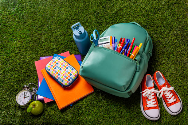 istock Back to School Backpack with Supplies Isolated on Grass 2166823347
