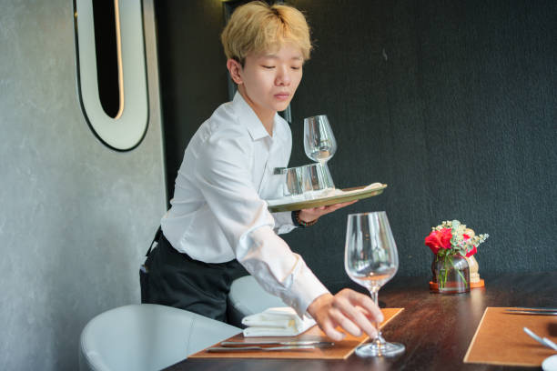 istock Asian male waiter in restaurant at work 2166824373