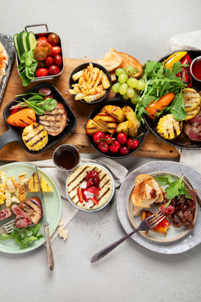 istock Table with grilled food. Pizza, corn, tomatoes, peppers, cooked meat. BBQ time 2166825889