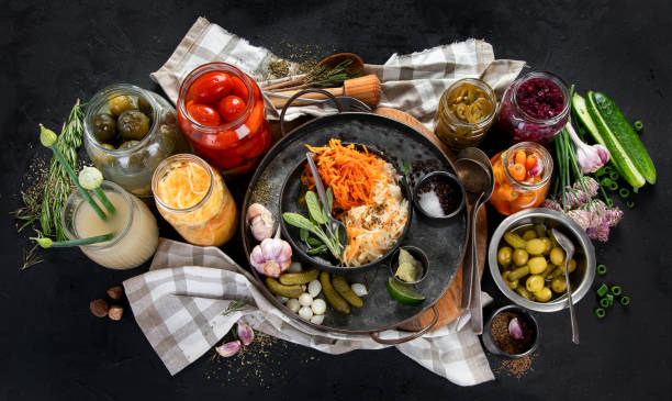 istock Fermented products on a dark background. Pickled vegetables in jars 2166825897