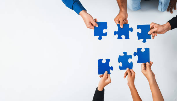 istock Business team joining jigsaw puzzle together. Prudent 2166826170