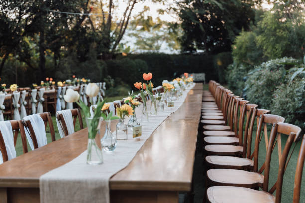 Colorful floral decoration for wedding banquet. Elegant atmosphere on a long narrow table decorated with various flowers at the wedding.