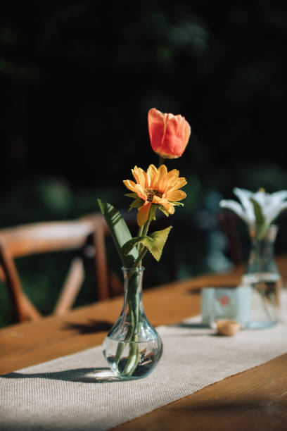 istock Flowers on a long dining table at a wedding 2166826428