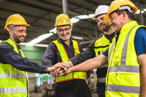 istock group of construction workers are high fiving each other 2166826442