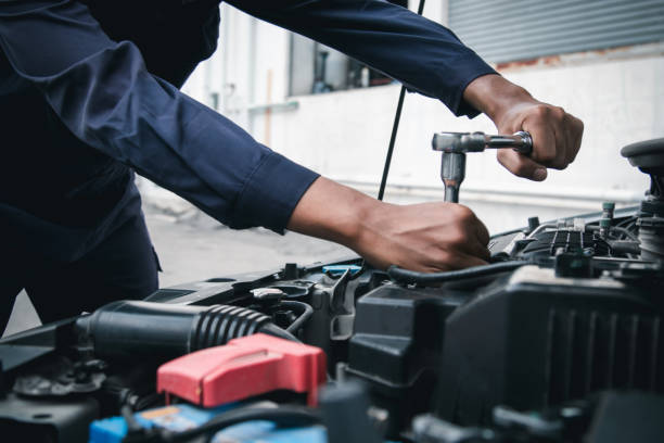istock Mechanic using wrench while working on car engine outside the service center , Repair and service. 2166831793