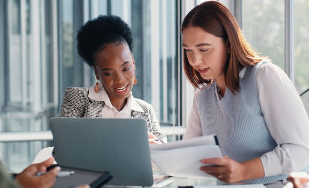 istock Business people, laptop and women with teamwork, documents and brainstorming for project. Employees, planning and consultants with computer, advice or help with company structure, folder or internet 2166832915
