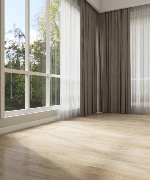 istock Empty room with double layer curtain, brown blackout and white sheer curtain in sunlight from backyard with trees on laminated parquet floor 2166833452