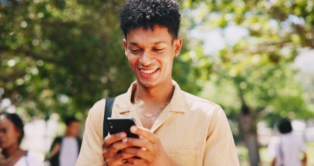istock Campus, park or happy man with smartphone in university for learning application or higher education. Social media text, smile or student on internet for academic registration or scholarship results 2166833485