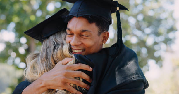 istock Graduation, achievement or happy students hug with certificate at university for education or success. College, scholarship or group of proud people at school campus with knowledge, smile or diploma 2166833501