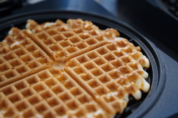 istock Belgian waffles in a frying pan on a kitchen table. 2166833693