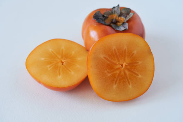 istock Fresh ripe persimmon fruit isolated on white background, close up 2166836587
