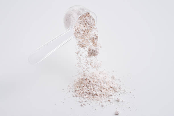 istock Powdered calcium citrate poured from a measured cup. White background isolated high speed freeze motion 2166836625