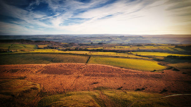 istock Breathtaking panoramic view of a rolling countryside with vibrant fields under a dynamic sky at Sycamore Gap, Northumberland, UK. 2166837034
