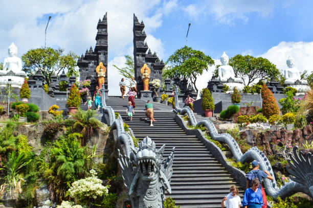 Banjar Tegeha, Buleleng, Bali, Indonesia - Aug 12 2024 : A stunning view of the majestic staircase leading to a Buddhist temple in Bali, adorned with intricate statues and visited by tourists.