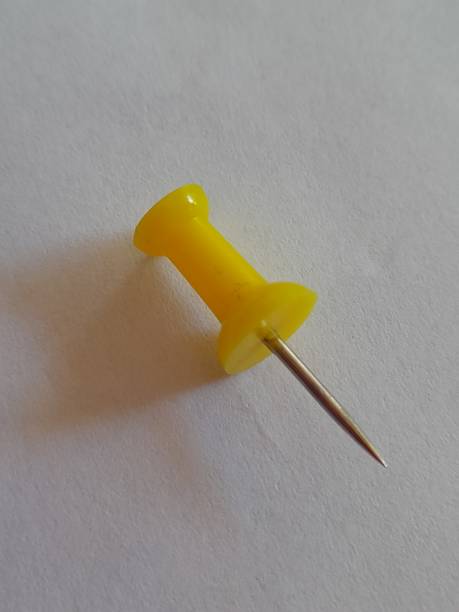 One yellow paper clip pin with white background