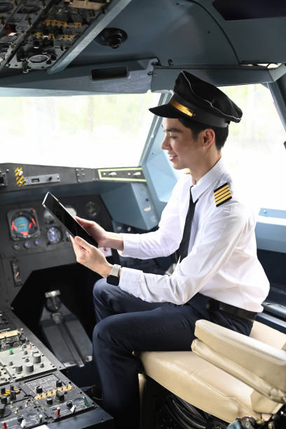 istock Pilot is sitting in the cockpit of an airplane and using digital tablet 2166841127
