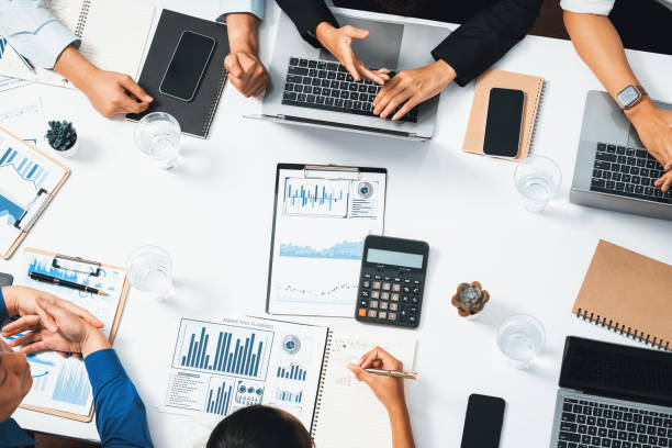 istock Analyst team utilizing BI Fintech to analyze financial data at table. Prudent 2166841869